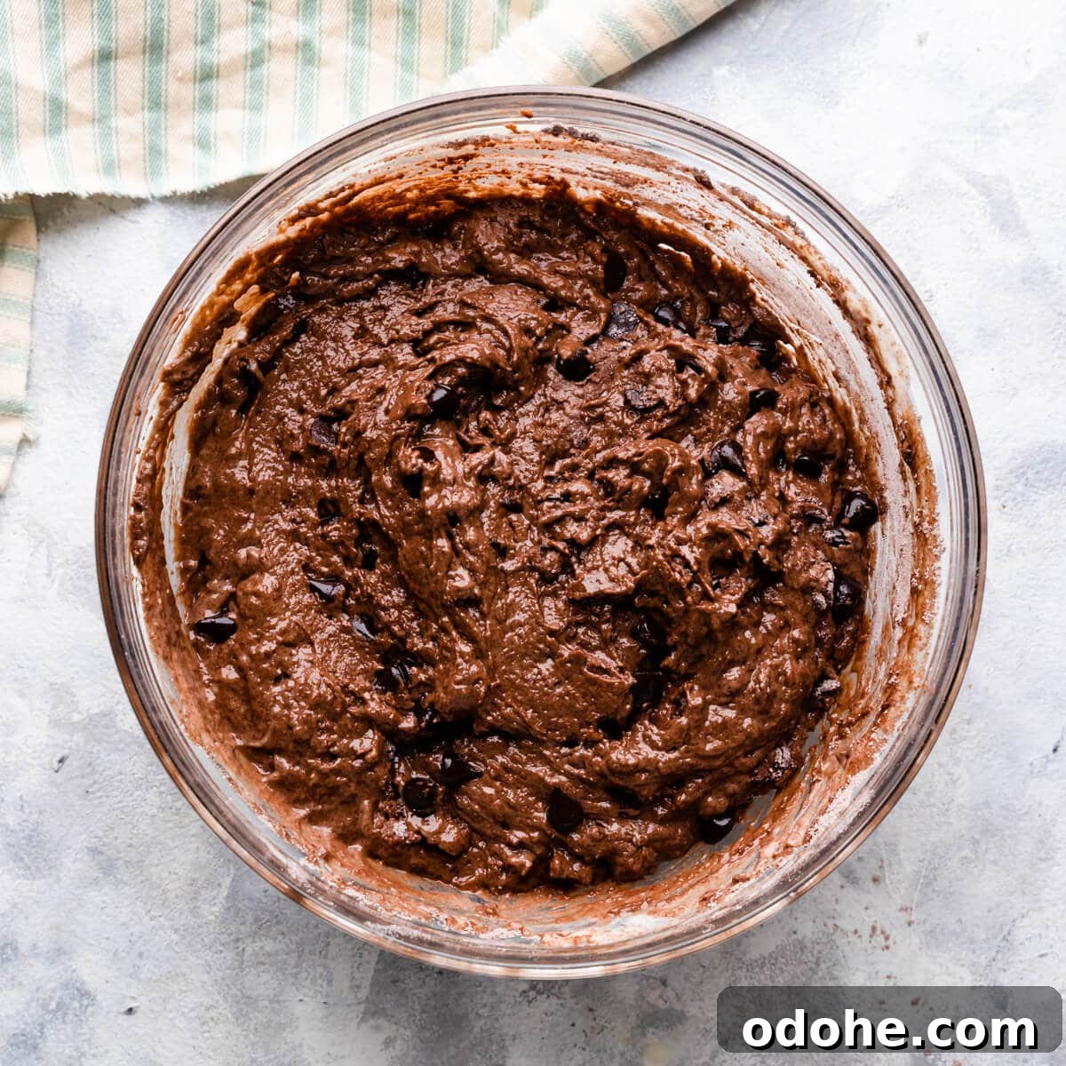 Chocolate Fudge Spiderweb Muffins Recipe — Decadent Halloween Treat 6 a bowl with chocolate fudge muffins batter.