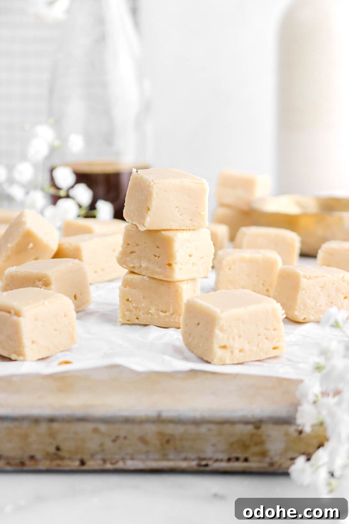 stacked maple fudge on upside down sheet pan.