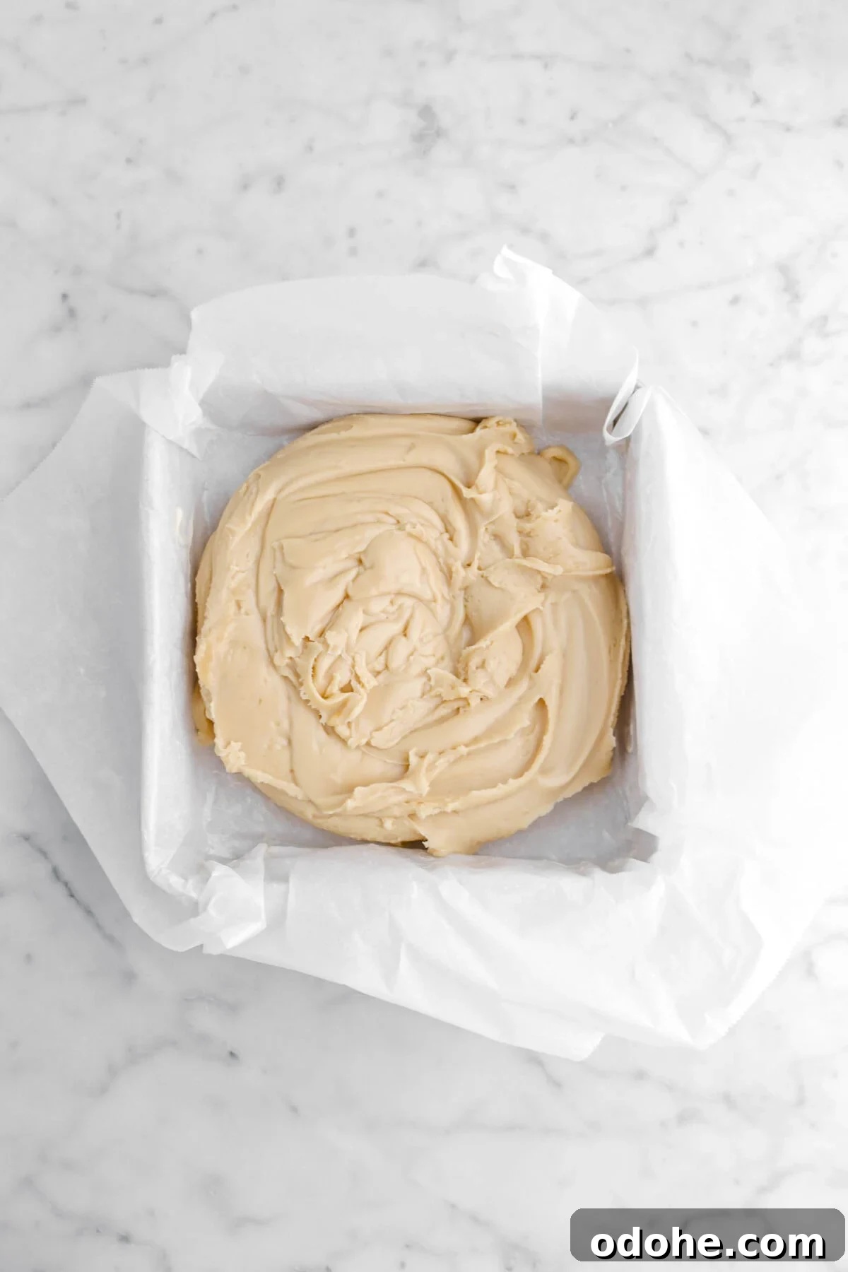 fudge piled in parchment lined cake pan.