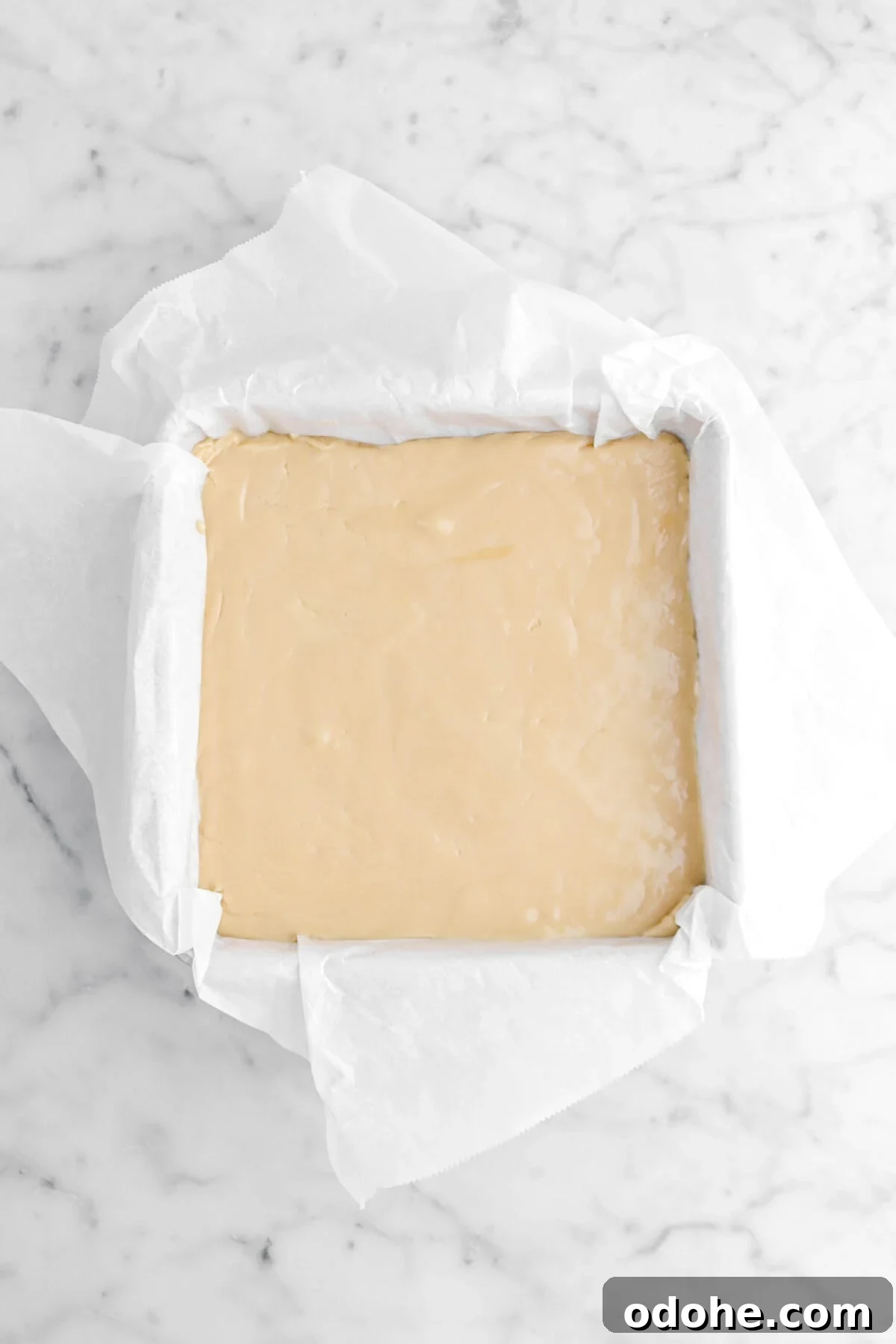 fudge smooth out in square cake pan lined with parchment paper.