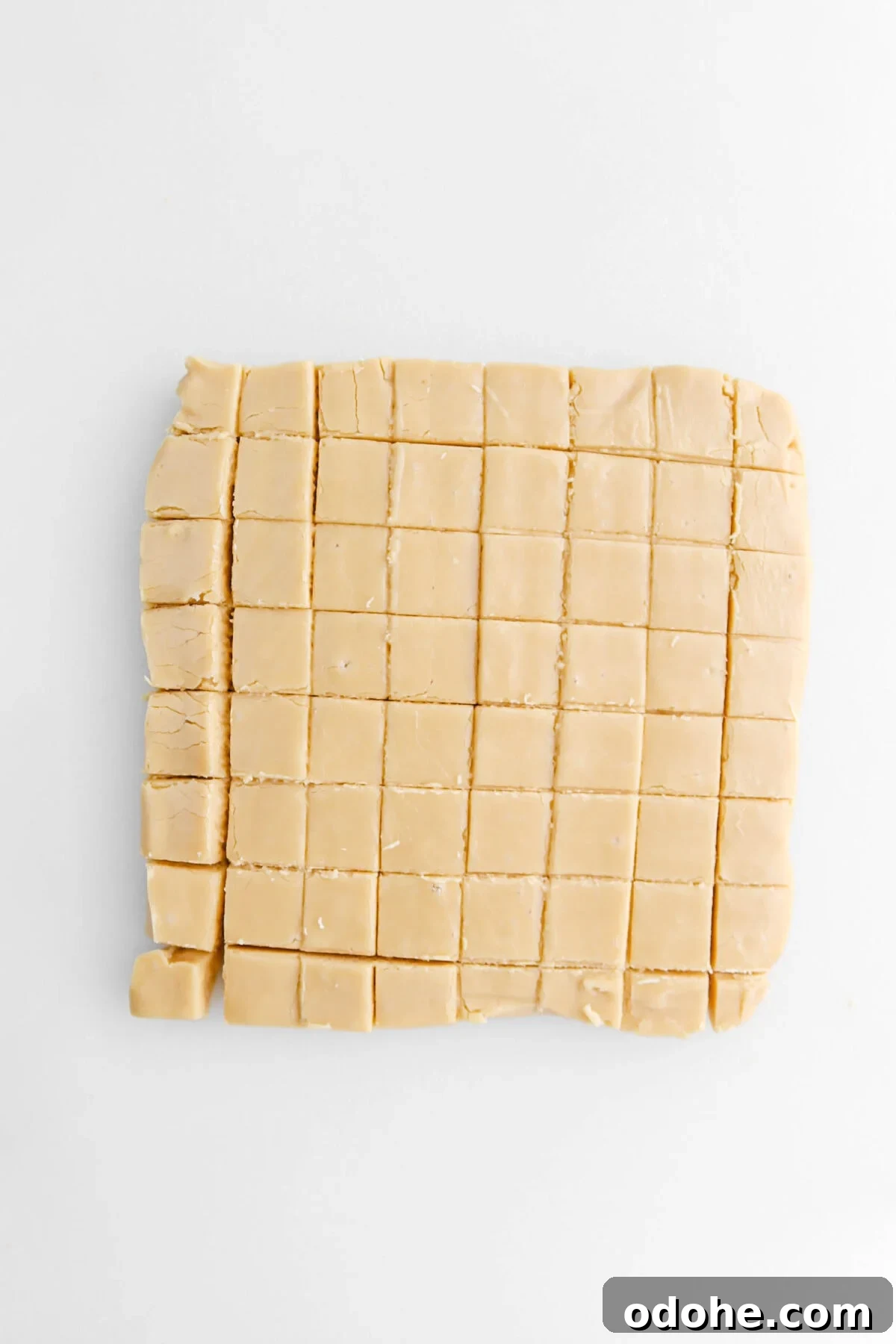 cut maple fudge on white surface.