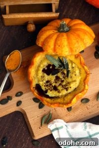Pumpkin-Millet Soup Served in Roasted Pumpkin Bowls 5 Easy Pumpkin Soup with Millet in Pumpkin Bowls - Served on the Wooden Board with a Spoon Full of Spice