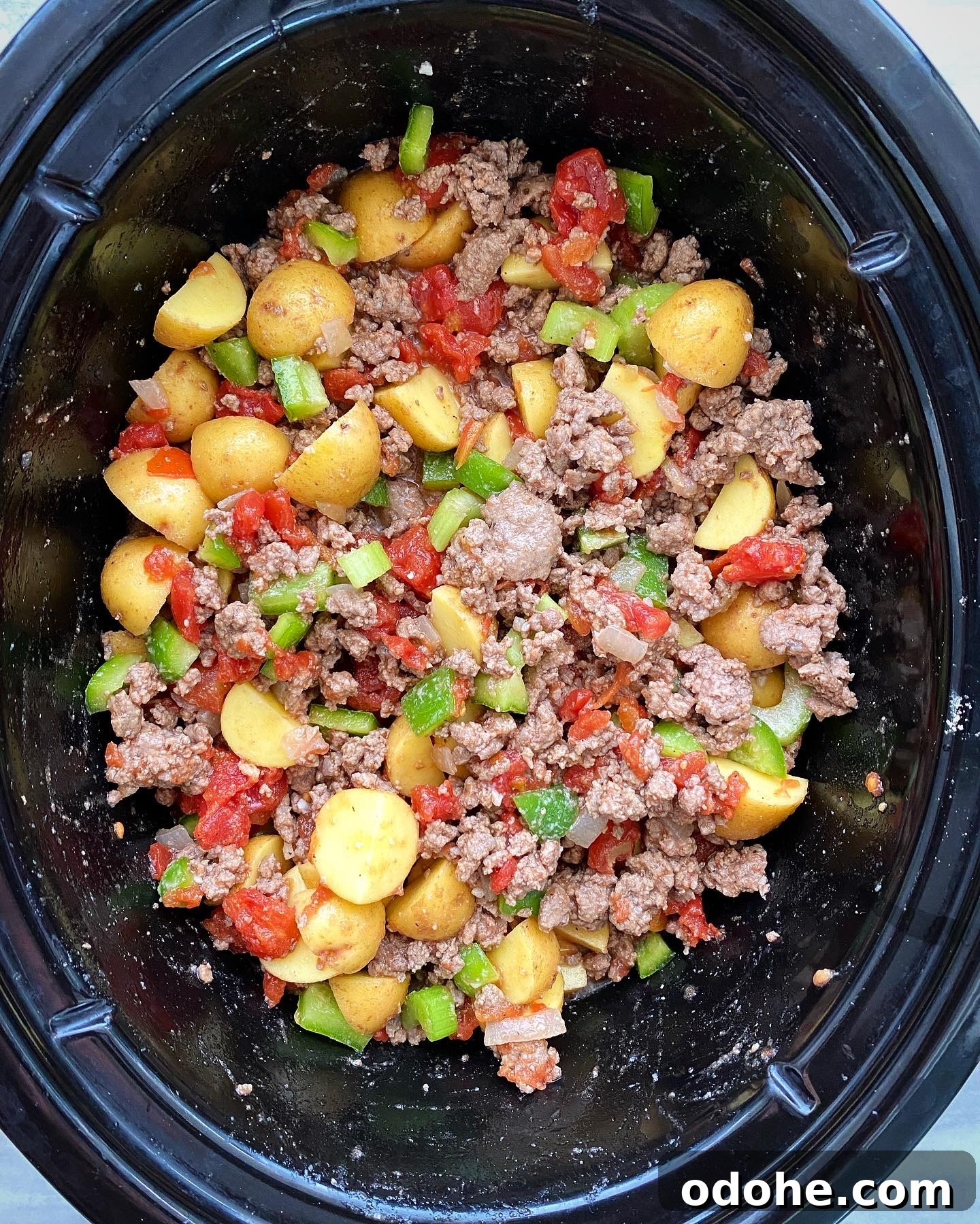 Slow Cooker Hamburger Stew Recipe — Hearty One-Pot Comfort Meal 4 overhead shot of uncooked hamburger stew in the slow cooker