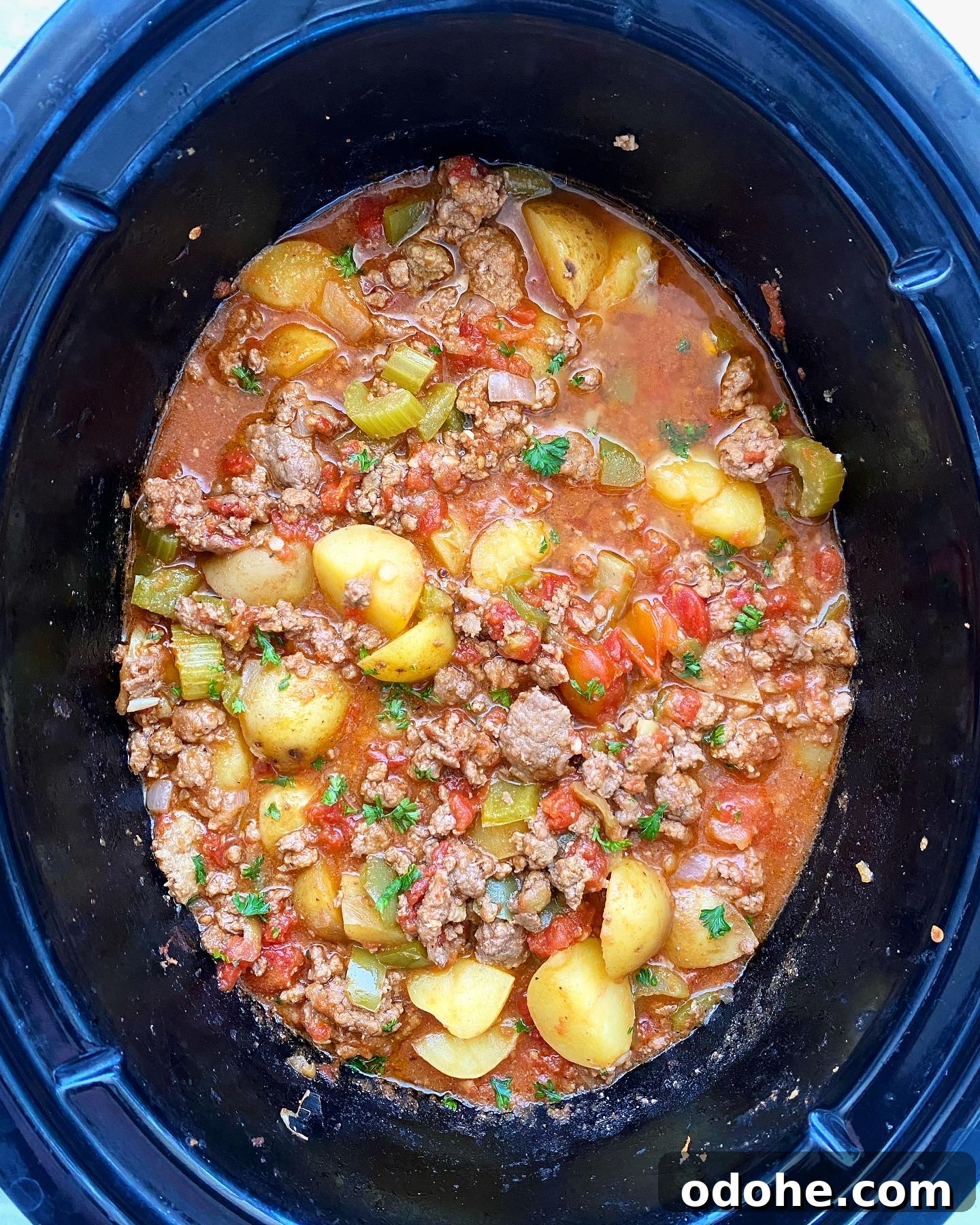 Slow Cooker Hamburger Stew Recipe — Hearty One-Pot Comfort Meal 5 overhead shot of cooked hamburger stew in the slow cooker