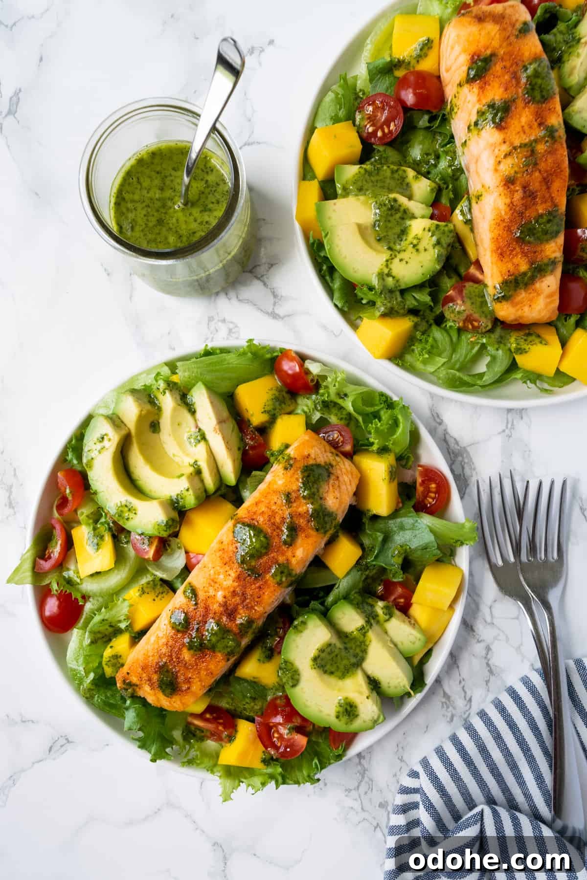 Mango and Salmon Salad with Lime-Dill Dressing 4 Mango Salmon Salad on 2 plates with 2 forks.