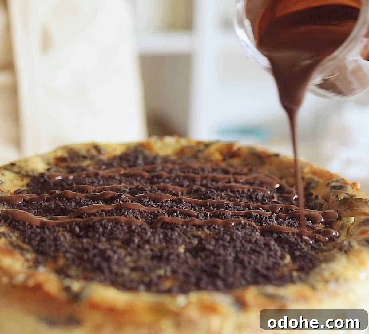 Topping an Oreo cheesecake with chocolate ganache.