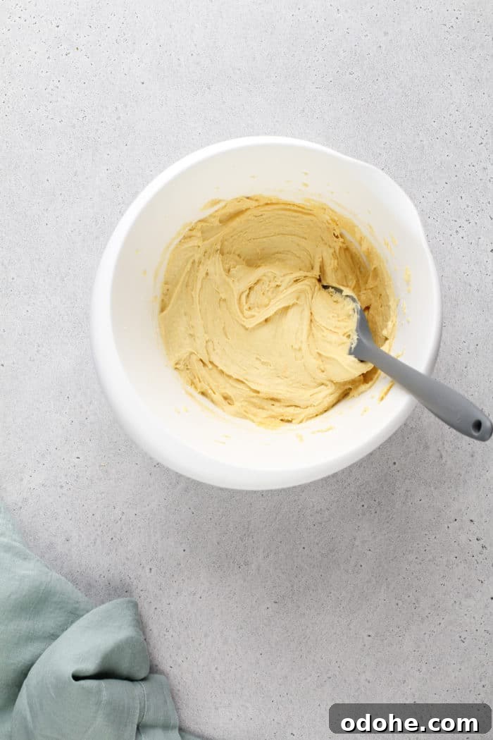 Gooey butter cake base batter in a white mixing bowl.