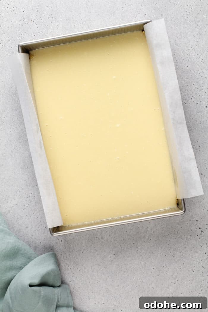 Assembled gooey butter cake in a pan, ready to go in the oven.