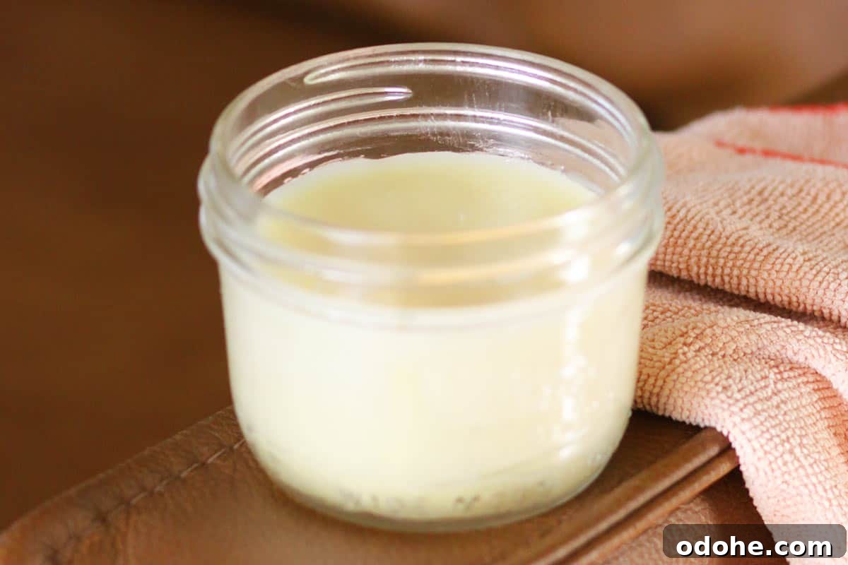 DIY Beeswax Leather Conditioner & Polish: Step-by-Step Guide 5 a jar of leather conditioner on a leather couch