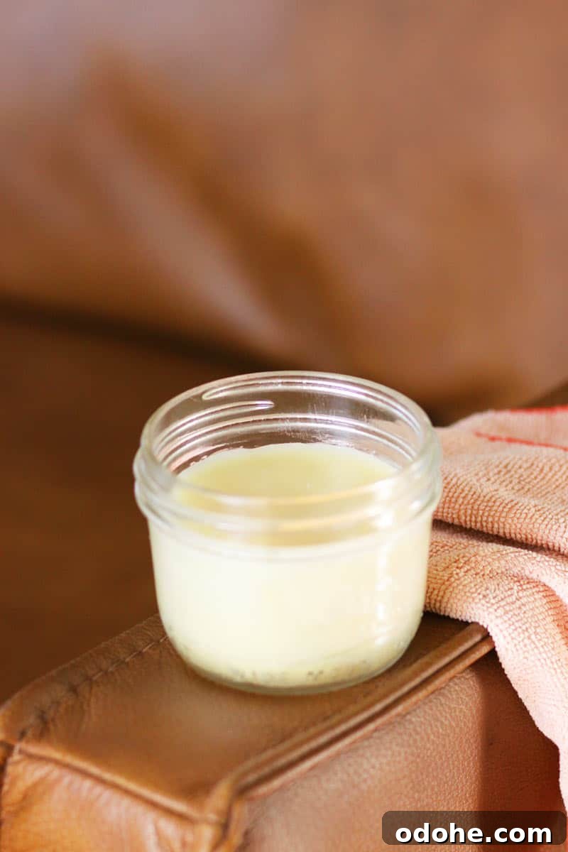 DIY Beeswax Leather Conditioner & Polish: Step-by-Step Guide 6 a jar of leather conditioner on a leather couch