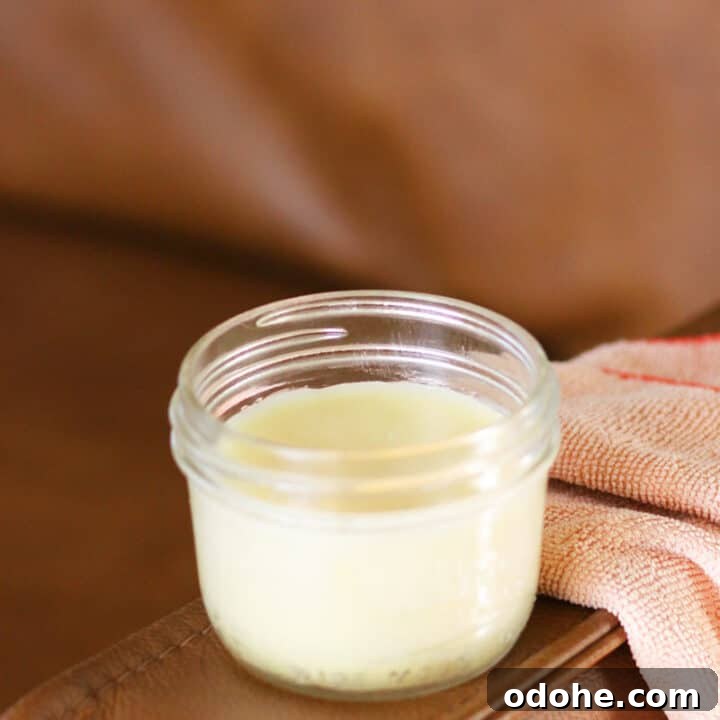 a jar of leather conditioner on a leather couch