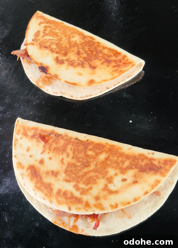 Smoked Brisket Quesadilla cooking on a Blackstone griddle