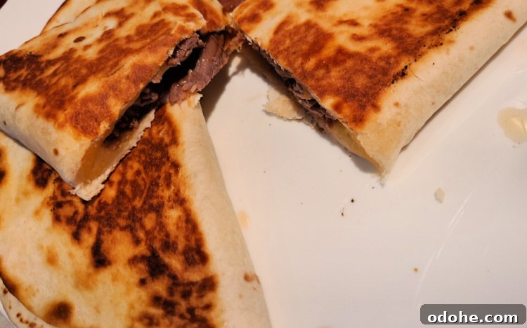 Brisket Quesadilla cooked on blackstone served on white plate