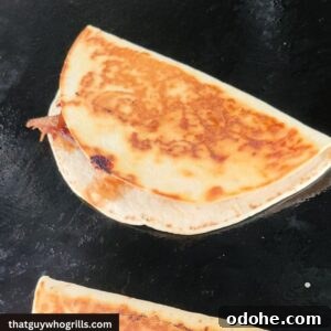 Brisket Quesadilla cooking on a blackstone griddle