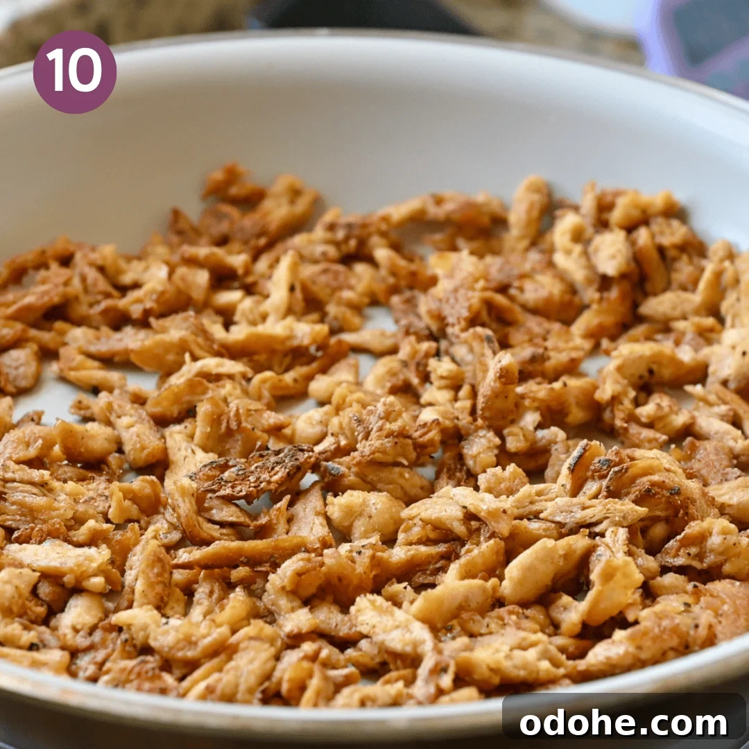 browned soy curls in frying pan after being cooked.