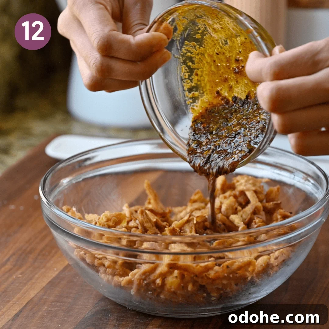 person pouring the tempered oil onto the soy curls.