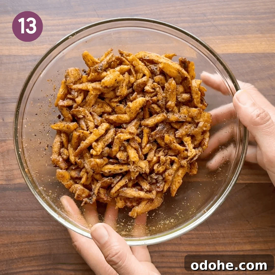 soy curls mixed with tempered oil in a glass bowl.