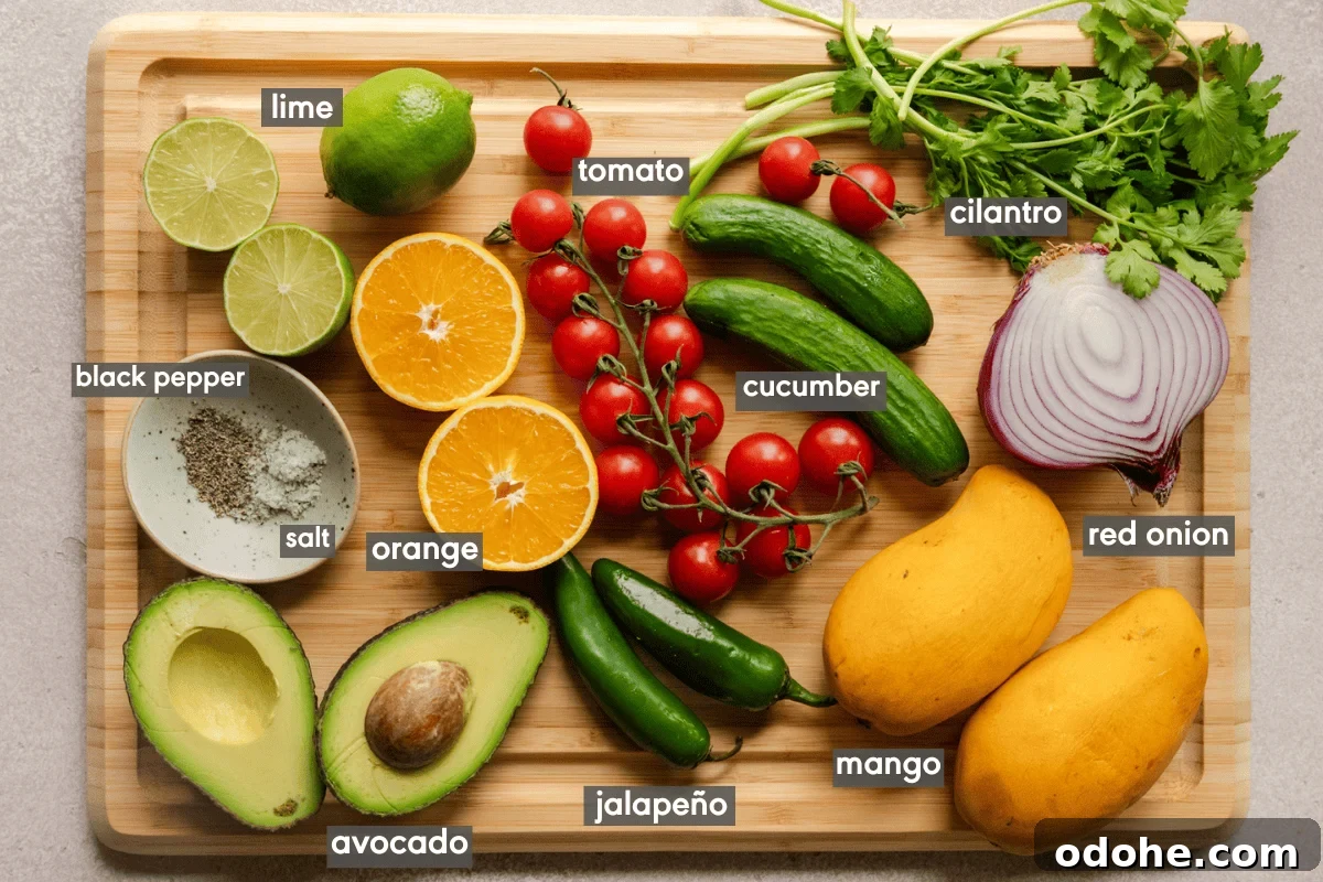 ingredients for mango avocado salsa on a wooden cutting board.