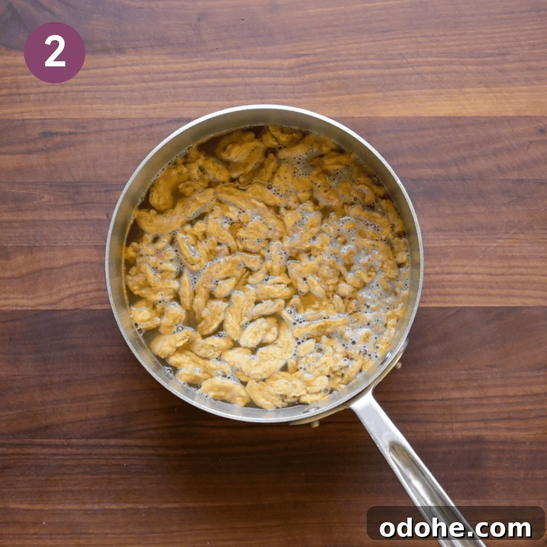 soy curls submerged in the hot broth in the saucepan.
