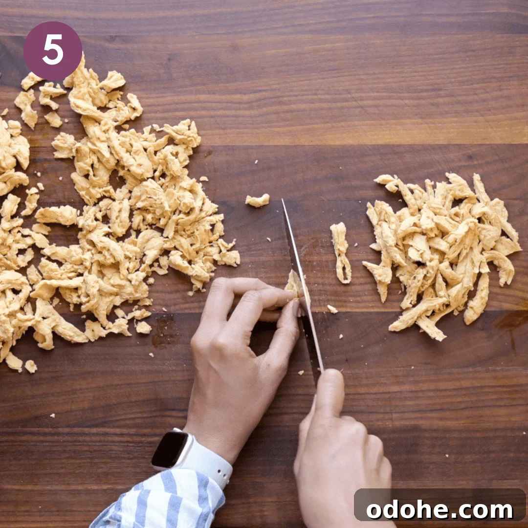 Person cutting soy curls into smaller pieces.