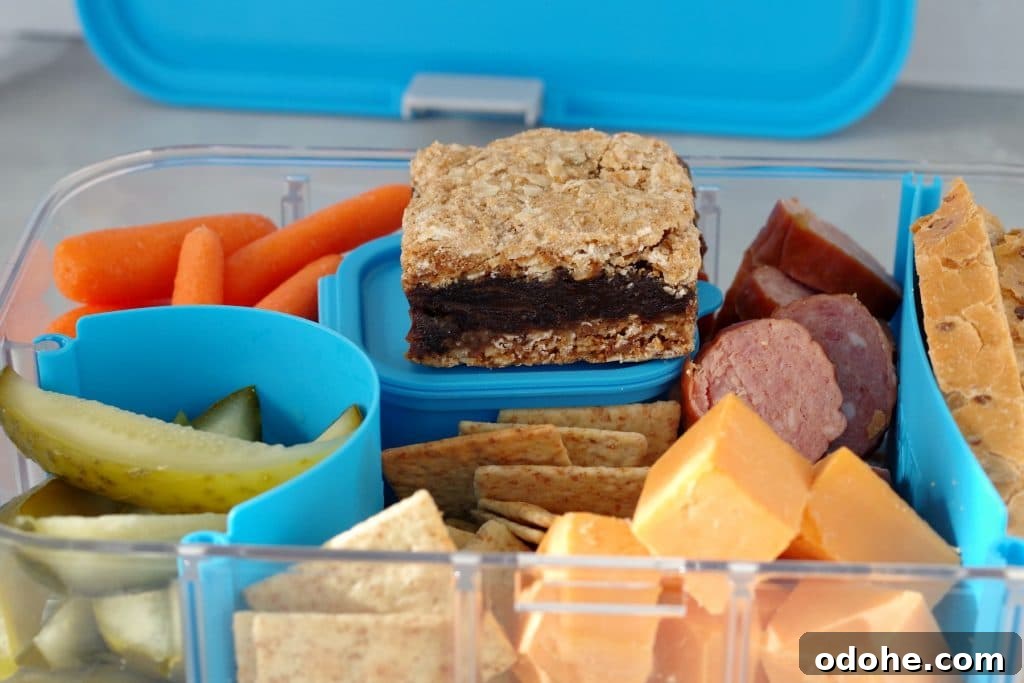 Ukrainian Bento Box Lunch: Compact Recipes for Packed Meals 4 Filled Ukrainian Bento box with date square and bento box lid in background
