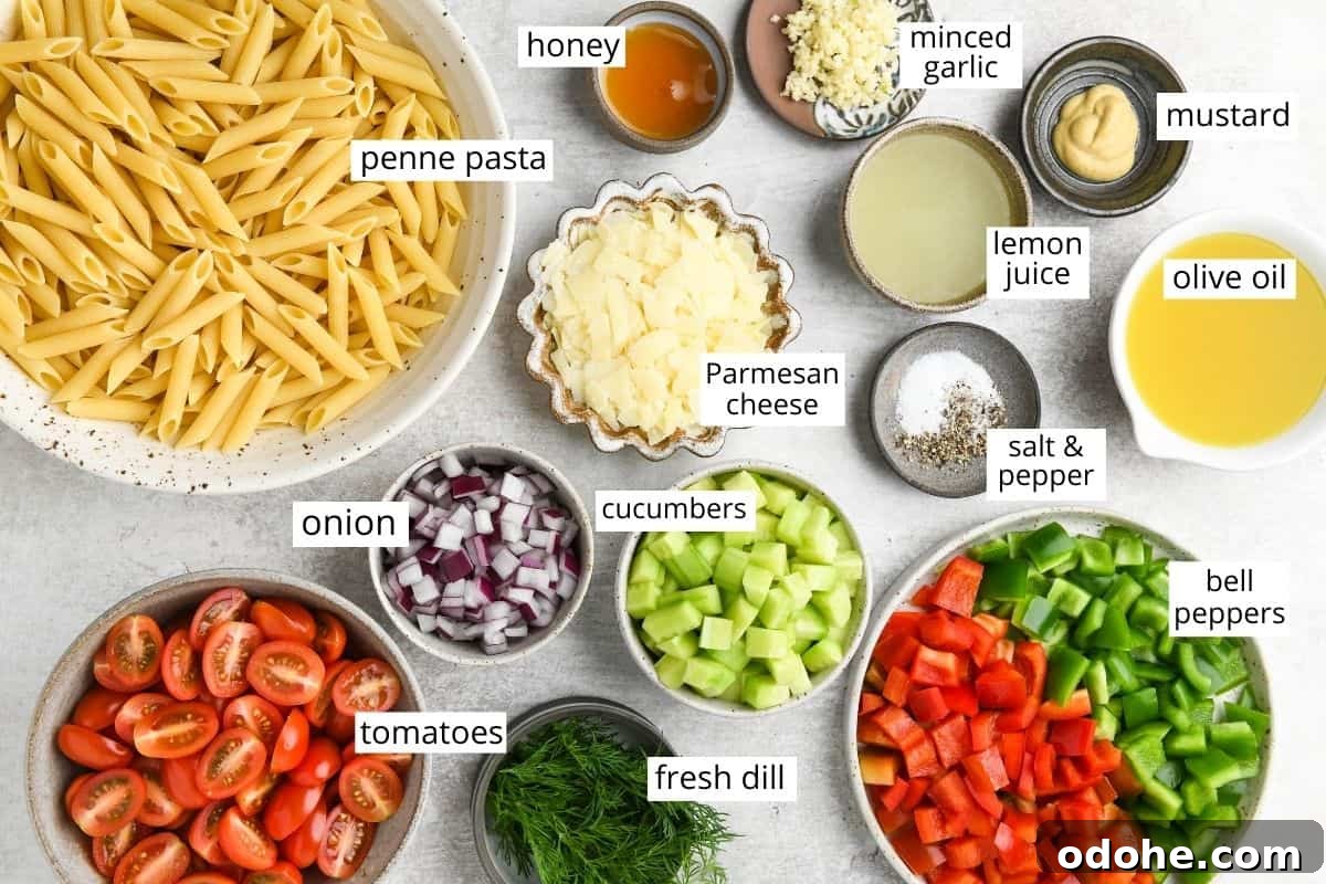 Zesty Lemon Pasta Salad with Fresh Herbs and Creamy Dressing 4 overhead photo of the ingredients in this lemon pasta salad all in bowls and labeled like pasta, honey, cucumbers, onions, tomatoes, olive oil, lemon juice and more