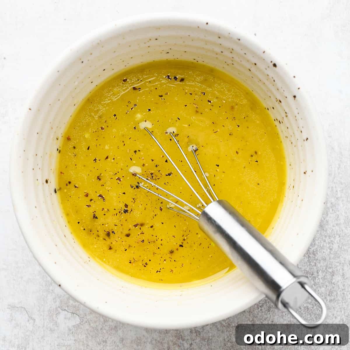 Zesty Lemon Pasta Salad with Fresh Herbs and Creamy Dressing 7 whisking the lemon dressing ingredients for this summer pasta salad