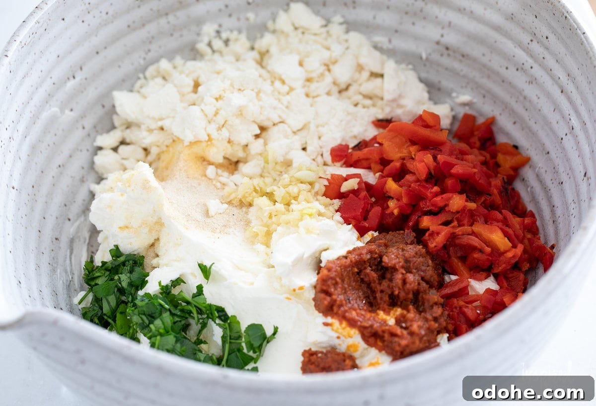 Smoky Roasted Red Pepper Dip Recipe 5 roasted red pepper dip ingredients in a bowl.