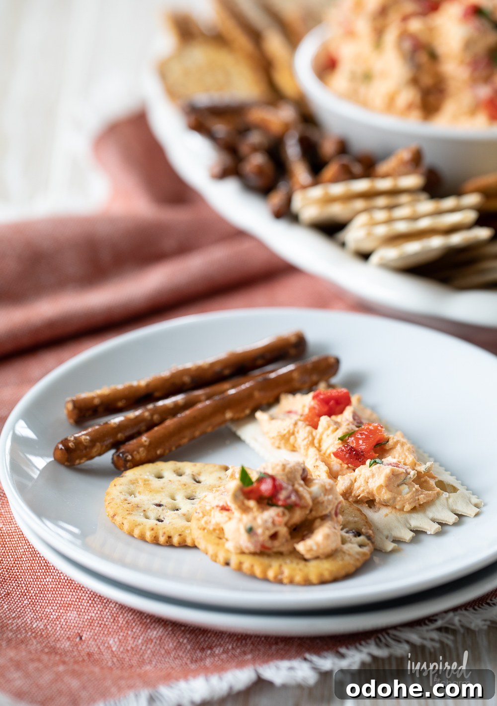 Smoky Roasted Red Pepper Dip Recipe 6 roasted red pepper dip on a plate with crackers.