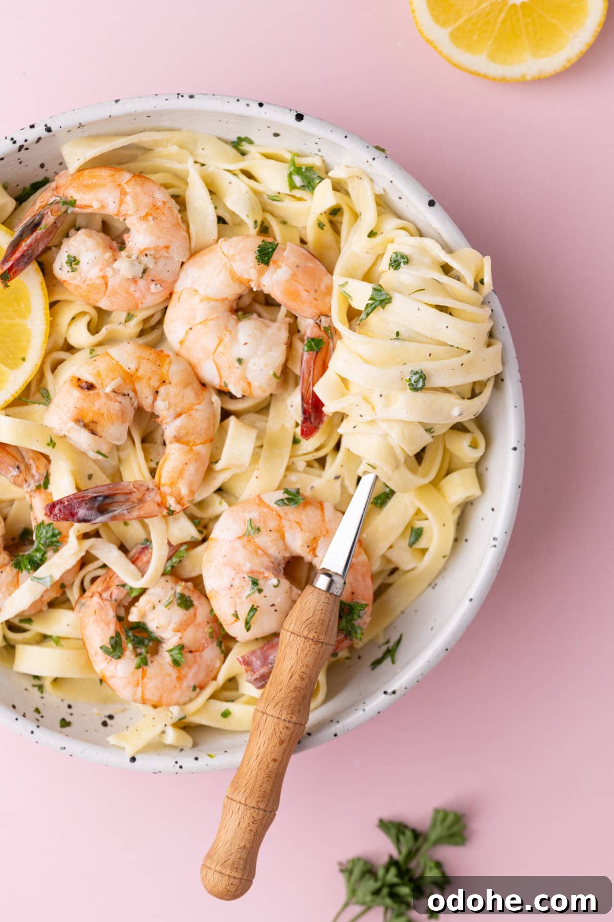 Creamy One-Pan Shrimp Scampi Recipe for Quick Weeknight Dinners 2 Creamy pasta twirled on a fork with large shrimp.