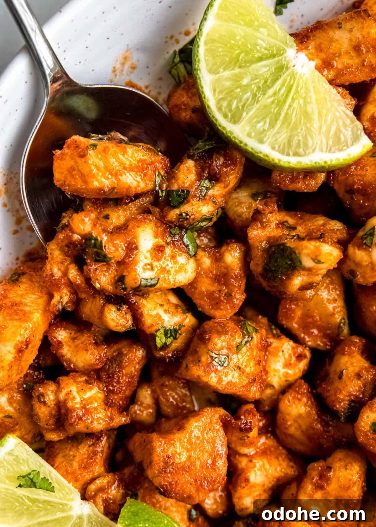 Cilantro Lime Chicken Bites for Air Fryer: Quick & Flavorful 2 close up image of cilantro lime chicken bites, a lime, and a silver spoon
