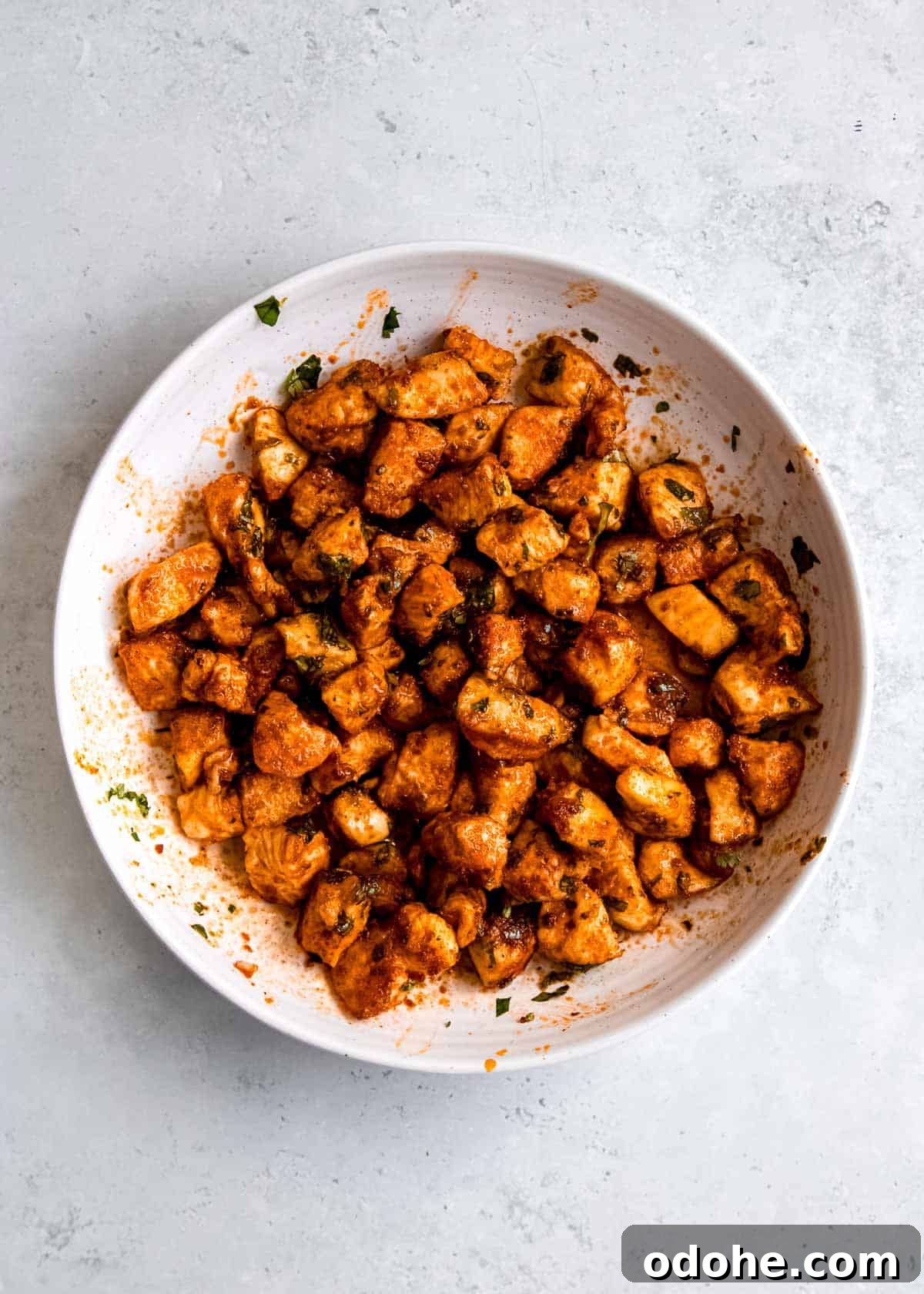 Cilantro Lime Chicken Bites for Air Fryer: Quick & Flavorful 9 cooked chicken bites being tossed in dressing