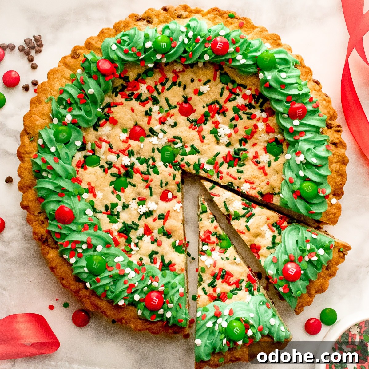 Festive Christmas Cookie Cake Recipe for Holiday Parties 2 overhead shot of Christmas Cookie cake with two slices cut