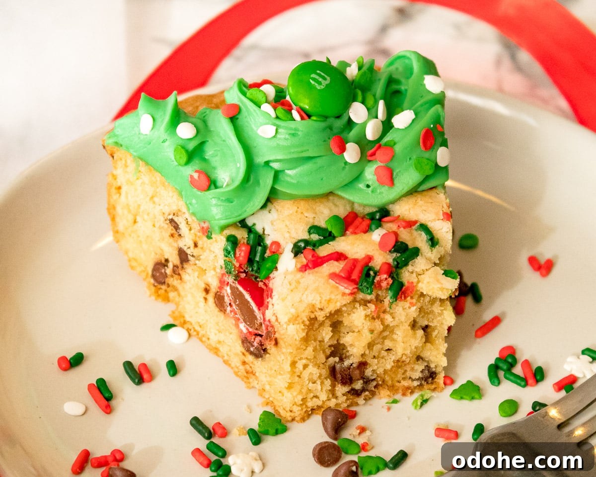 Festive Christmas Cookie Cake Recipe for Holiday Parties 5 slice of Christmas Cookie cake with a bite taken out