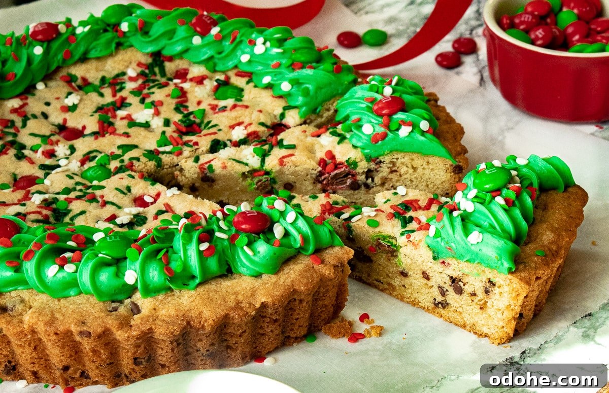Festive Christmas Cookie Cake Recipe for Holiday Parties 6 Side view of christmas cake with a slice cut out