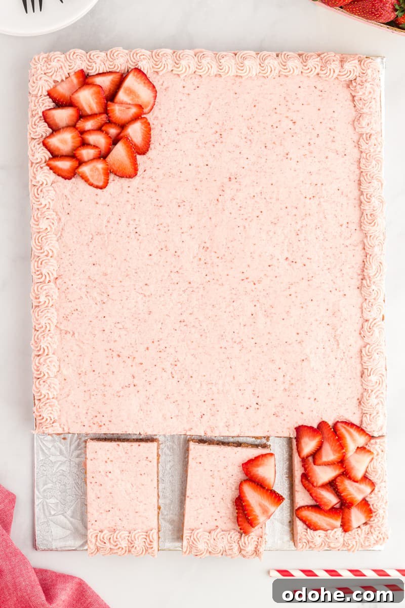 Moist Strawberry Sheet Cake Recipe for Parties and Potlucks 2 a strawberry cake on a white plate with strawberries on it.