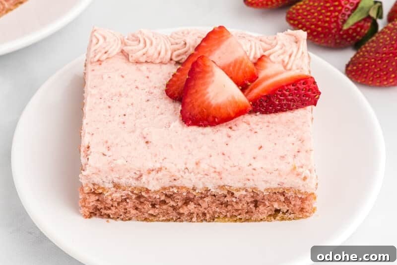 Moist Strawberry Sheet Cake Recipe for Parties and Potlucks 3 strawberry sheet cake slices on white plates.