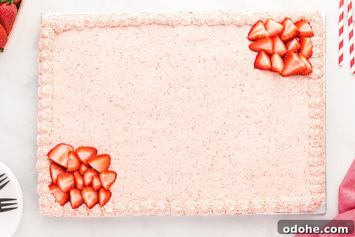 Moist Strawberry Sheet Cake Recipe for Parties and Potlucks 12 A frosted and decorated strawberry sheet cake.