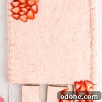 Moist Strawberry Sheet Cake Recipe for Parties and Potlucks 4 a strawberry cake on a white plate with strawberries on it.