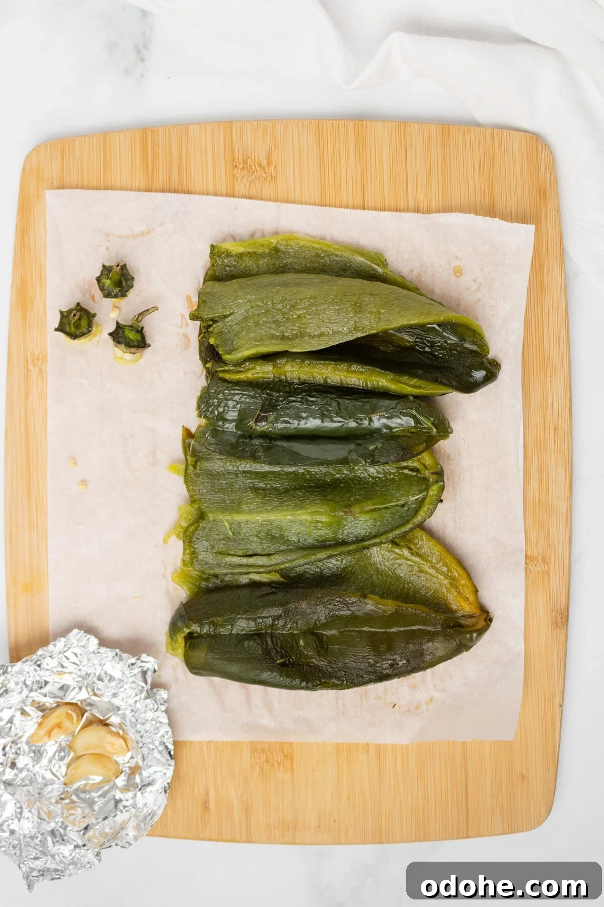An overhead image of removing the seeds of the poblano peppers.