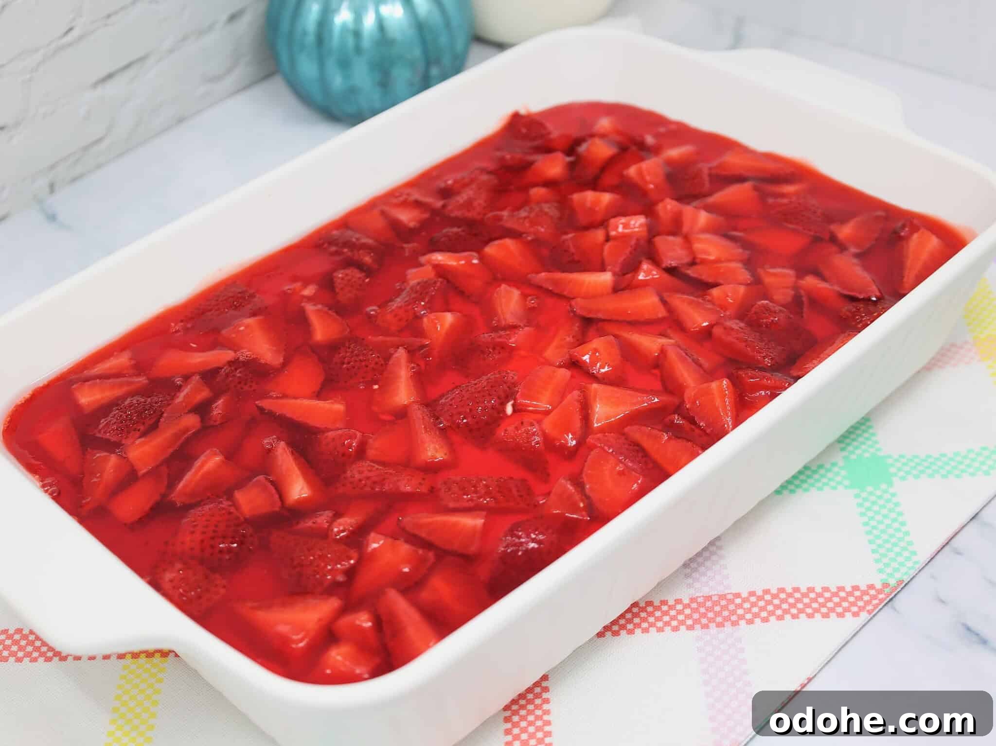 Make-Ahead Strawberry Pretzel Salad with Fresh Berries 4 Unchilled strawberry pretzel salad with fresh strawberry topping before setting in refrigerator