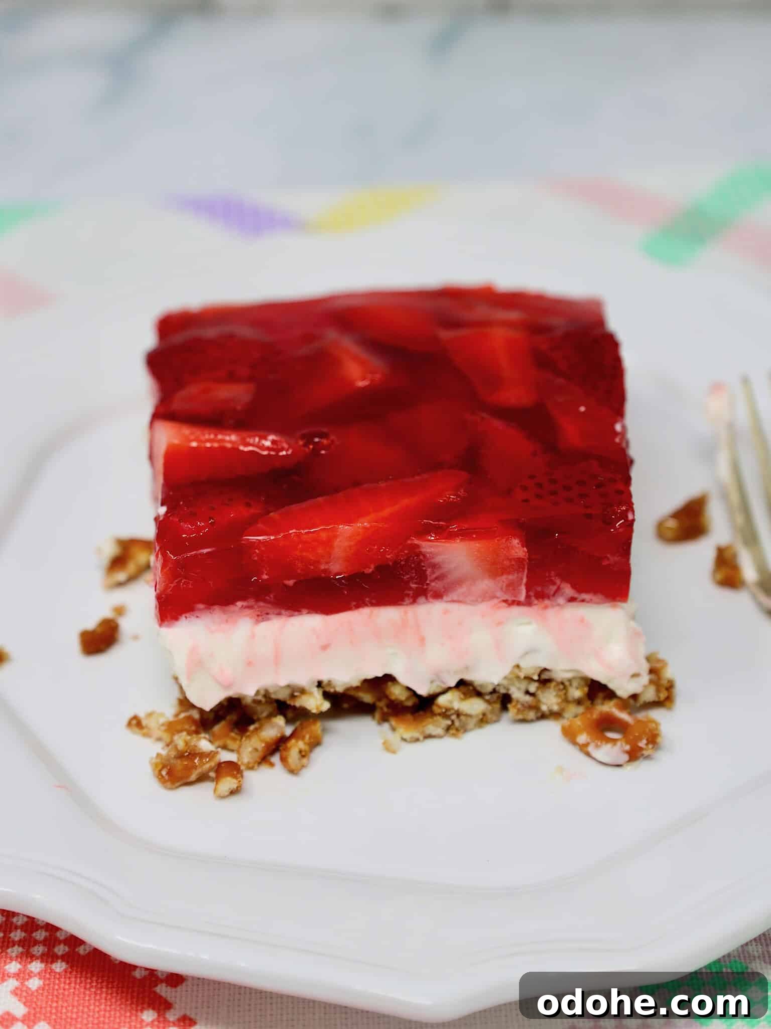 Make-Ahead Strawberry Pretzel Salad with Fresh Berries 6 Slice of strawberry pretzel salad showing layers of pretzel crust, cream cheese filling, and strawberry gelatin topping
