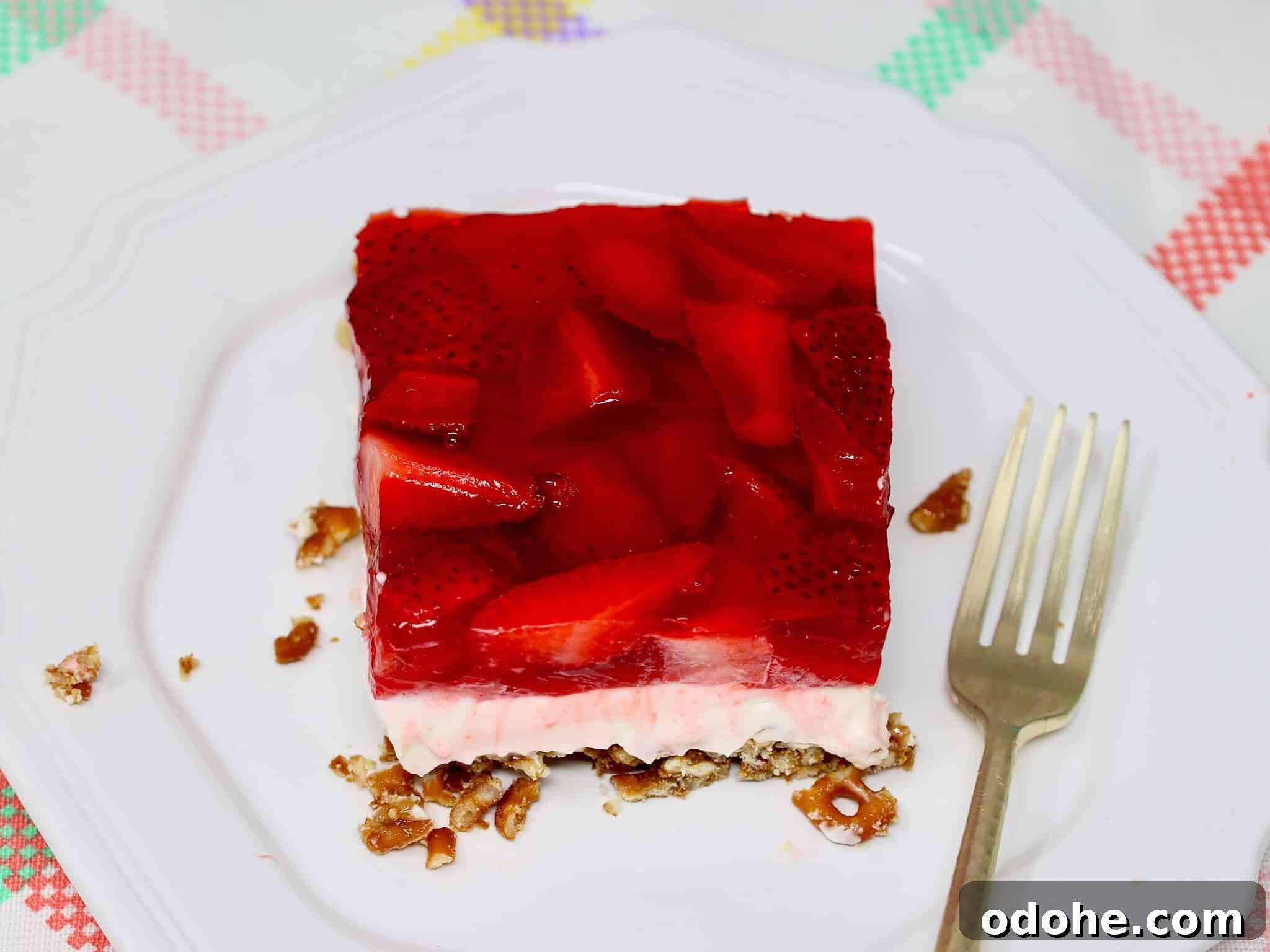 Make-Ahead Strawberry Pretzel Salad with Fresh Berries 7 Close-up of strawberry pretzel dessert highlighting the creamy middle layer and fresh strawberry topping
