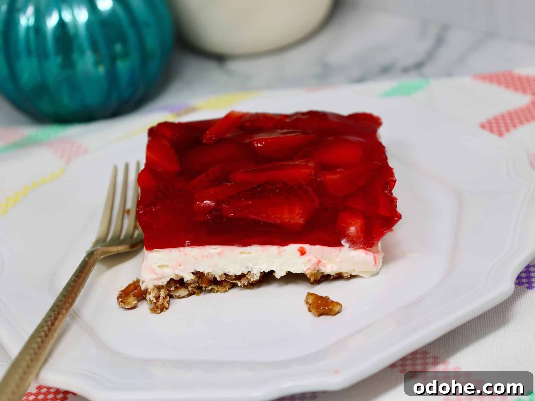 Make-Ahead Strawberry Pretzel Salad with Fresh Berries 8 Spoon scooping strawberry pretzel salad showing soft cream layer and crunchy pretzel crust texture