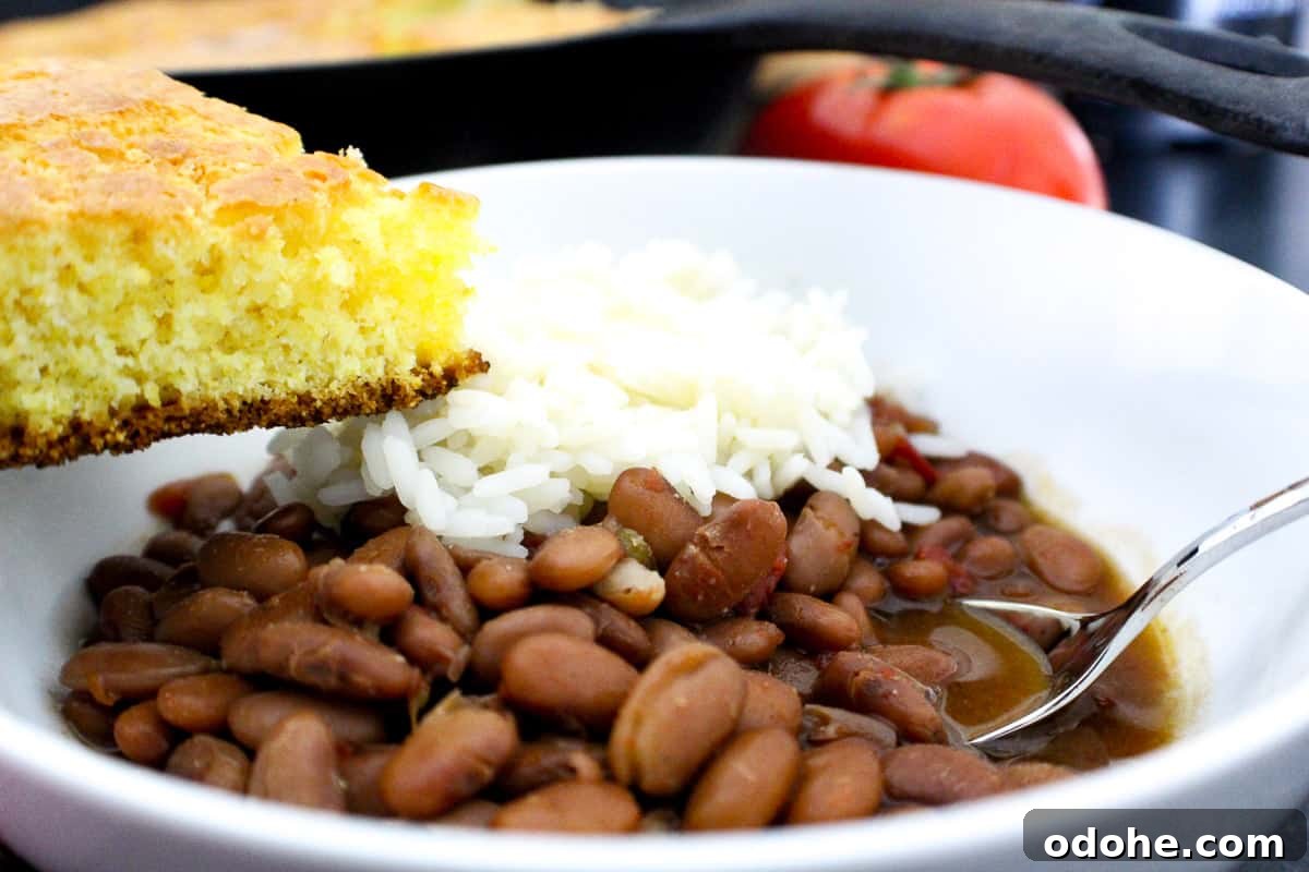 Southern Pinto Beans and Rice Recipe — Classic Soulful Side Dish 5 Pinto beans and rice in a bowl with a side of cornbread.