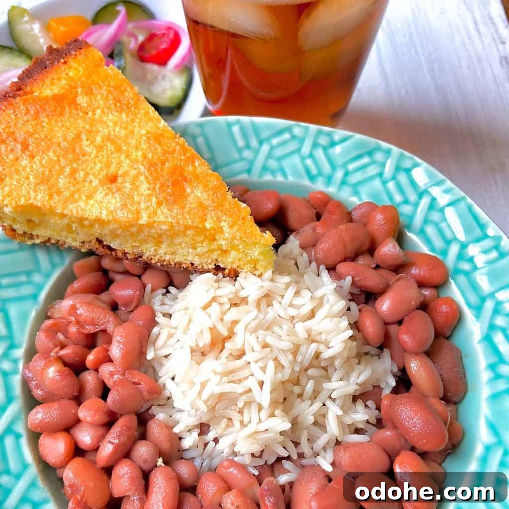 Southern Pinto Beans and Rice Recipe — Classic Soulful Side Dish 6 Pinto beans and rice with a slice of cornbread on the side.