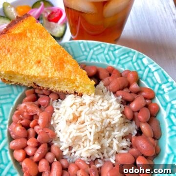 Southern Pinto Beans and Rice Recipe — Classic Soulful Side Dish 7 Pinto beans and rice with a slice of cornbread on the side.