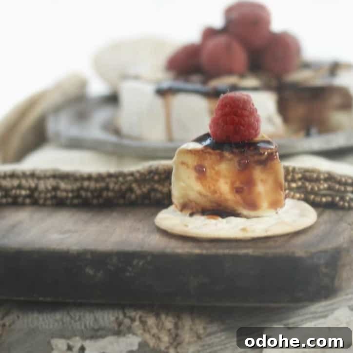 Toasted Almond and Raspberry Baked Brie Recipe for Entertaining 5 One slice removed from the Toasted Almond Raspberry Baked Brie