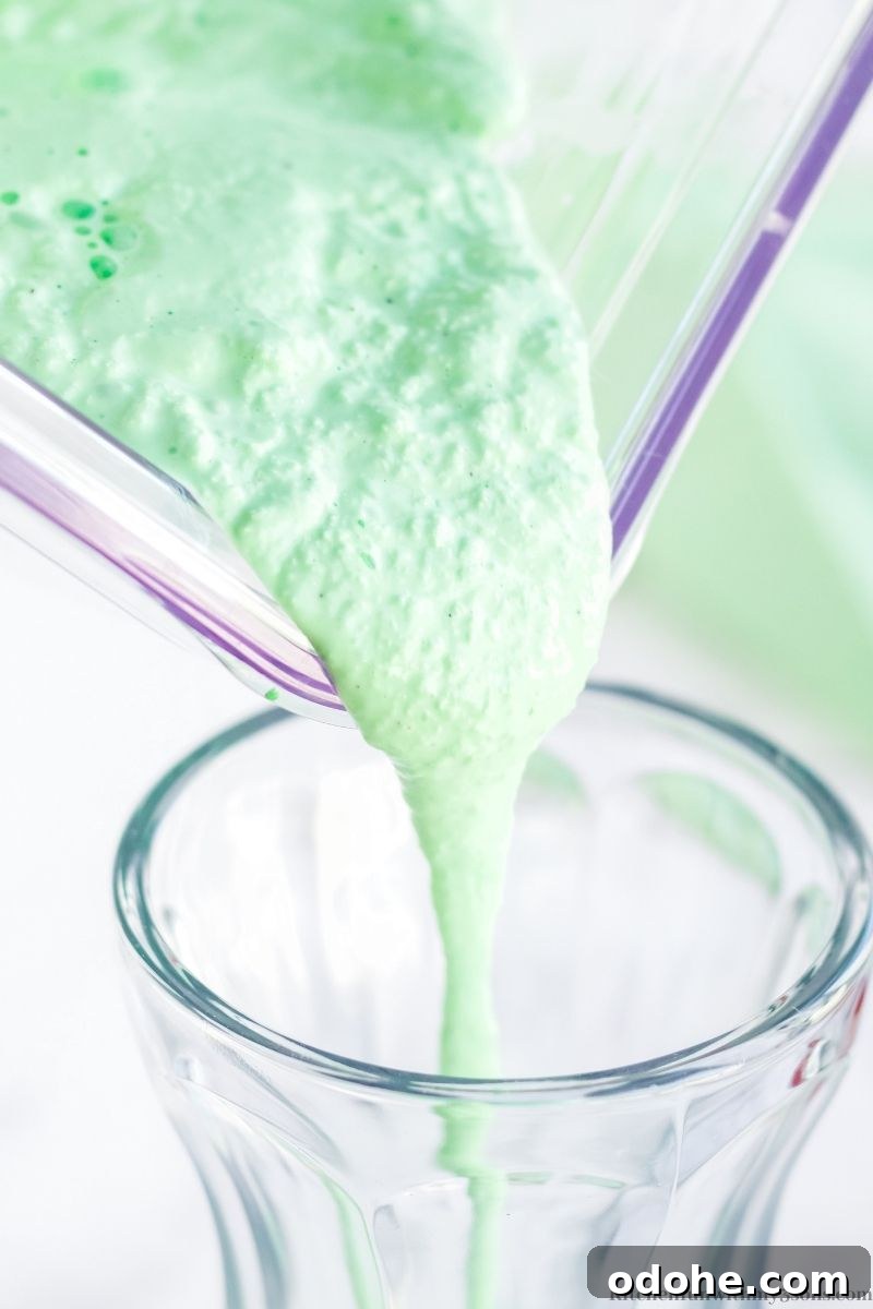 Shamrock shake is poured from the blender into a milkshake glass.