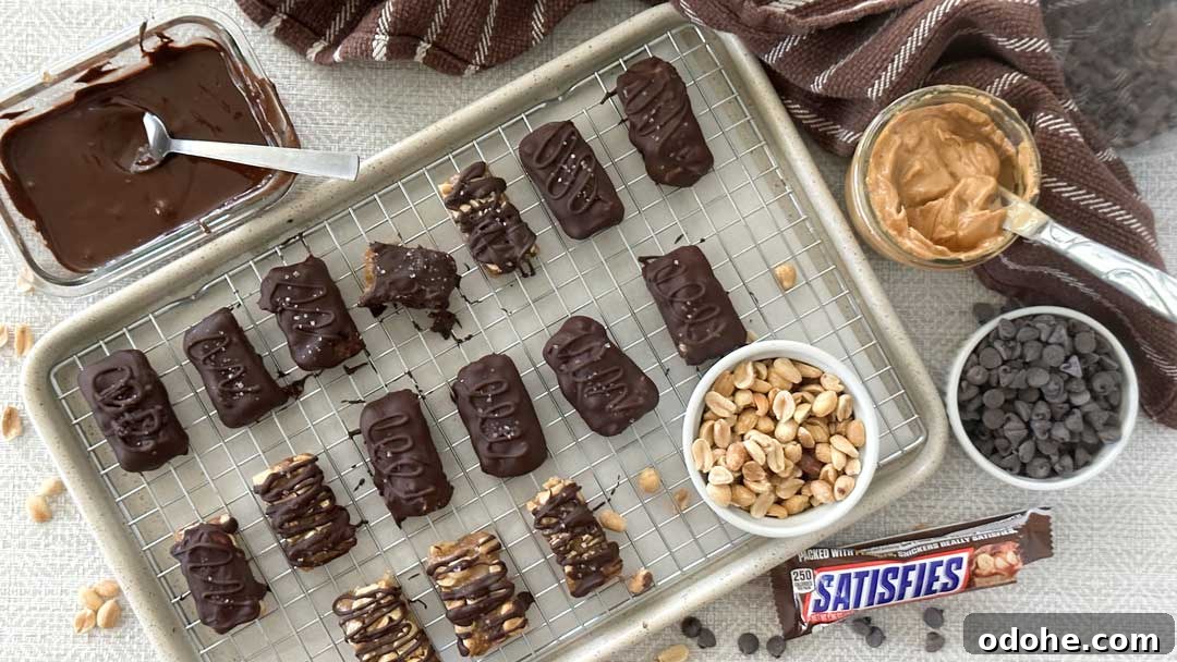 Gluten-Free Snickers Copycat Recipe: Homemade Chocolate Caramel Nougat 17 The top view of gluten-free Snickers bars on top of a cooling rack with a bowl of peanuts.